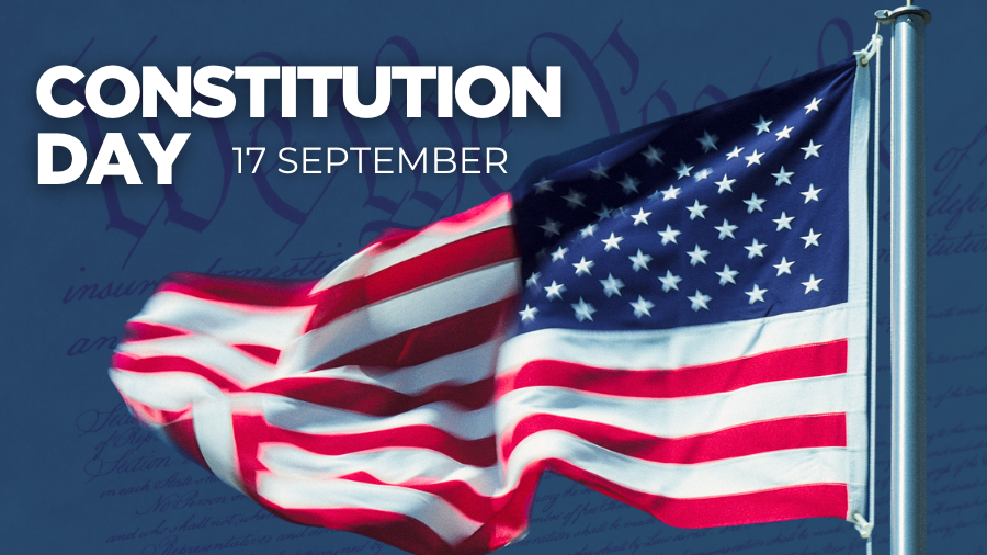 A vibrant American flag waves prominently against a deep blue background featuring faded constitutional text. Bold white text reads "CONSTITUTION DAY" in large letters with "17 SEPTEMBER" positioned below in smaller text.