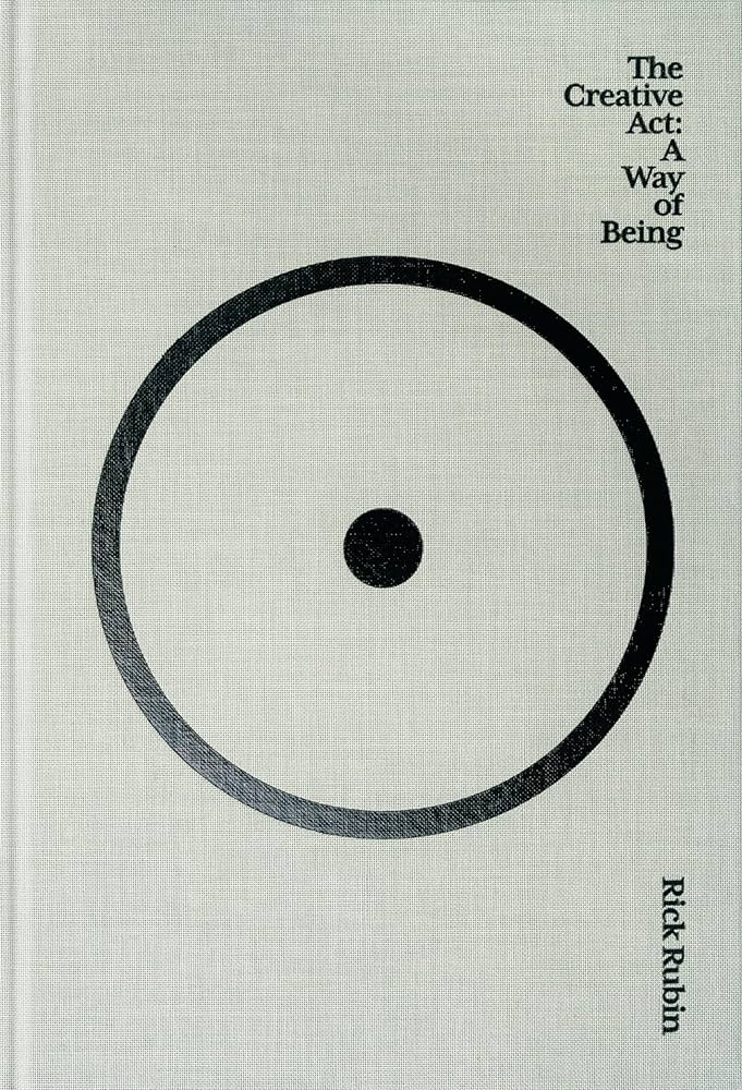 Minimalist cover with a gray textured background and a large black circle enclosing a dot, evoking Zen aesthetics. Title appears in small serif font in the top right corner, and the author's name, Rick Rubin, runs vertically.