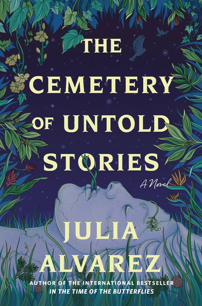 Book cover of The Cemetery of Untold Stories by Julia Alvarez, showing a pale stone face lying in grass with a plant sprouting from its lips, framed by leaves.