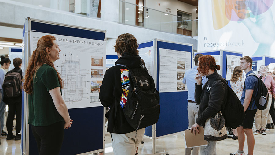 Students looking aroundin the library during research week
